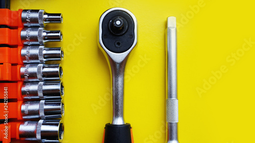 Wrench head bits for the screwdriver and other tools on bright yellow background