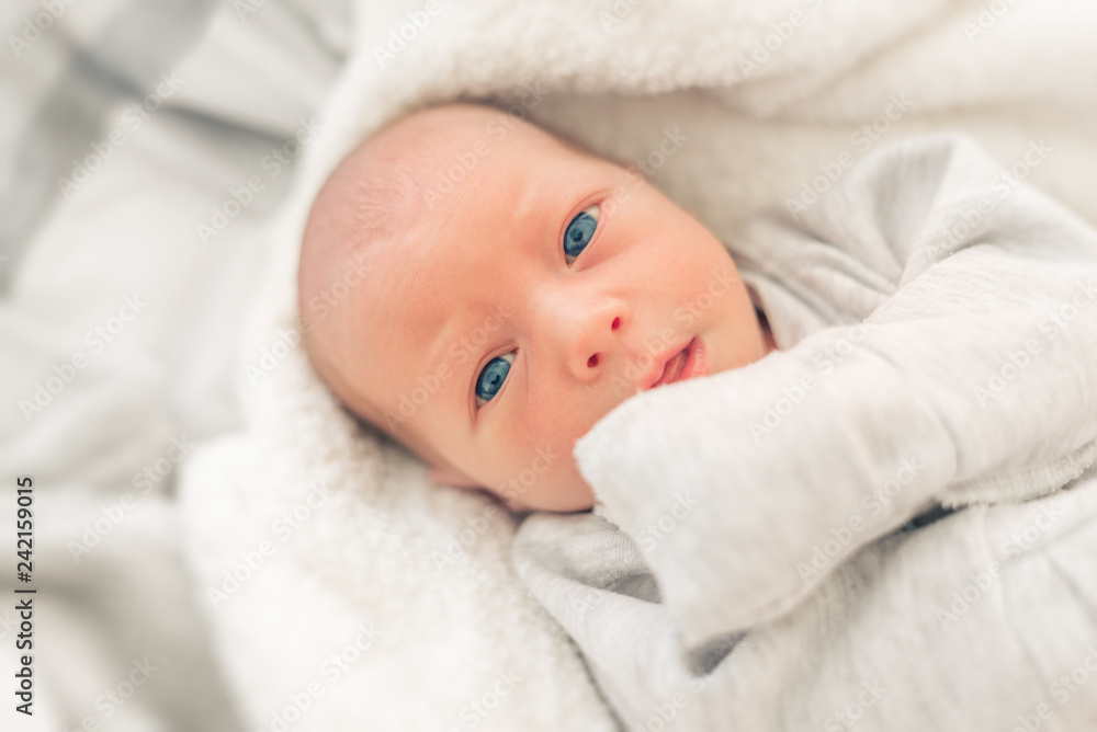 Portrait of a baby girl close-up. Baby in the crib. Portrait of a baby girl close-up. Baby in the crib.