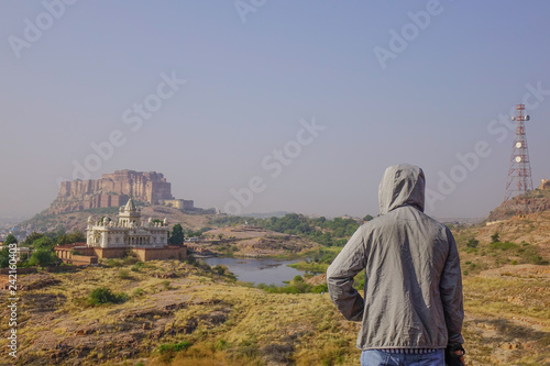 Photography An Asian man standing on the hill