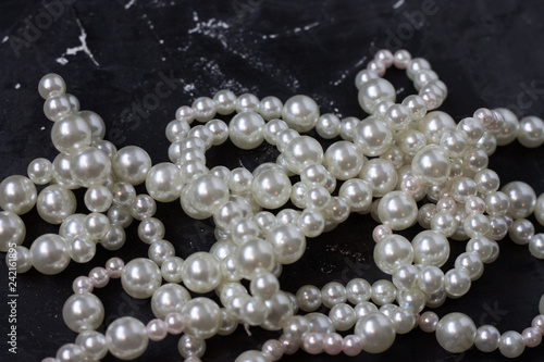 white pearl beads on black background,