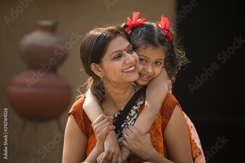 portrait of loving Indian mother and daughter at village