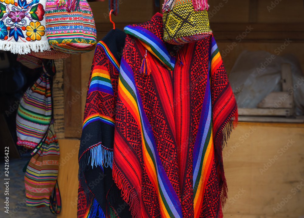 beautiful colorful Peruvian poncho in the market in Machu Picchu, one of  the New Seven Wonder of The World, Cusco Region Peru, Urubamba Province.  Selective focus Photos | Adobe Stock