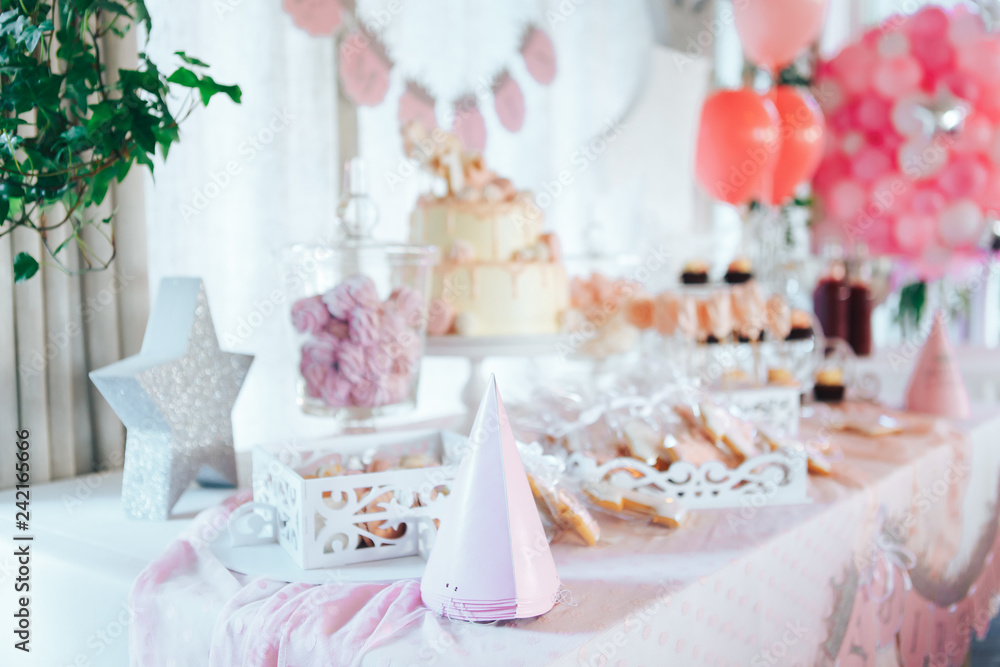 Pink candy bar for first birthday. Sweet table and big cake for first birthday Pink candy bar for first birthday. Sweet table and big cake for first birthday