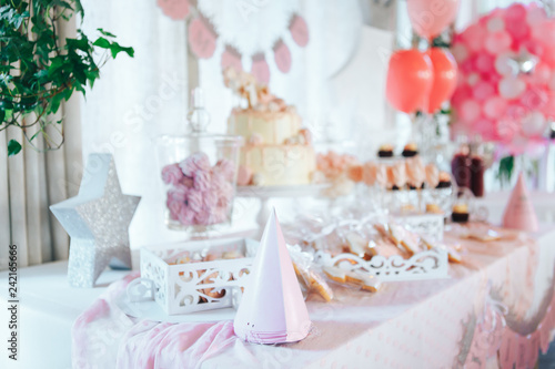 Pink candy bar for first birthday. Sweet table and big cake for first birthday © Svetlana