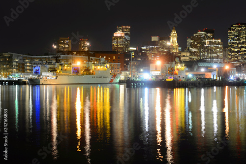 Boston City Skyscrapers, Custom House and USCGC Spencer (WMEC-905) at night from East Boston in Boston, Massachusetts, USA.