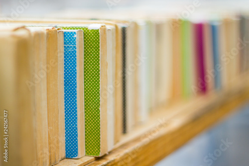 row of old books on a shelf in a book store