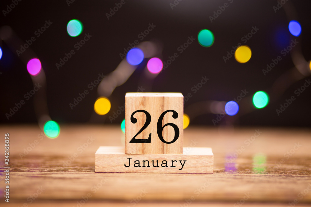 Naklejka premium January 26th. Day 26 of month at center of dark background with garland bokeh. Winter time, year concept.