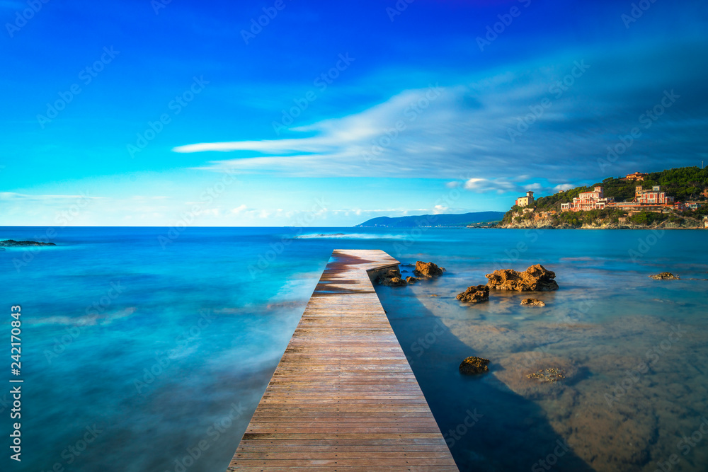 Castiglioncello bay wooden pier, rocks and sea. Tuscany, Italy.