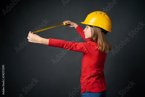 Decoration, renovation and reconstrucion concept. Girl with measuring tape photo