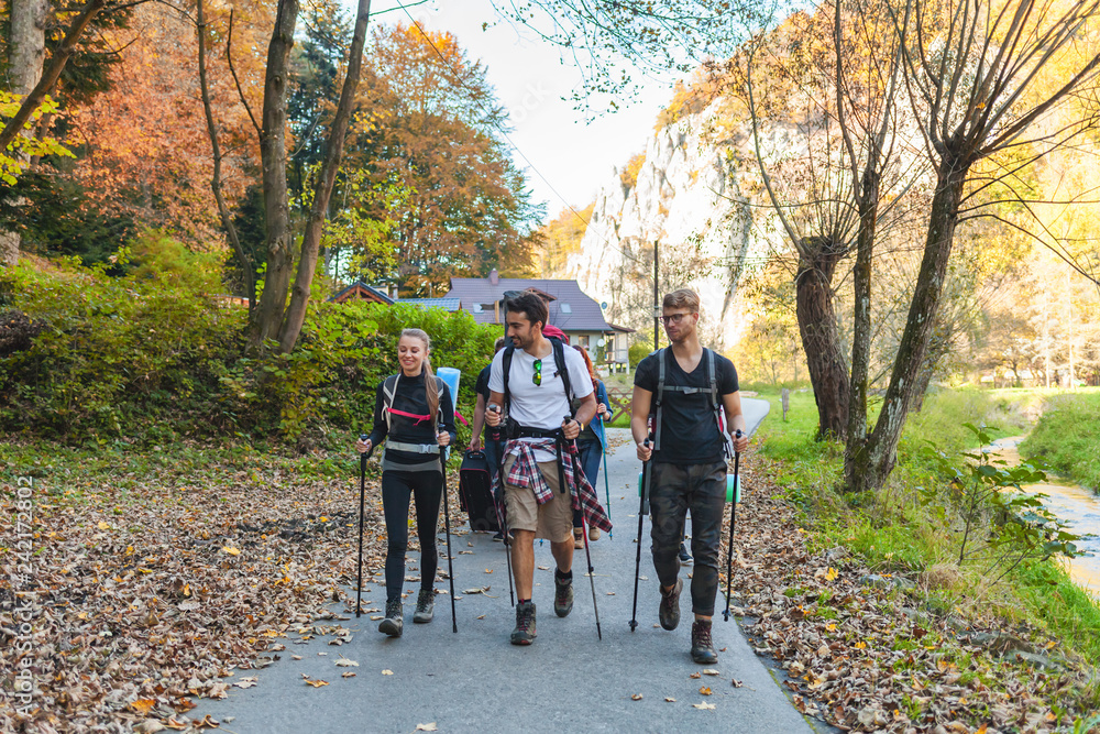 Friends with backpacks walking outdoor together, trekking and tourism Friends with backpacks walking outdoor together, trekking and tourism