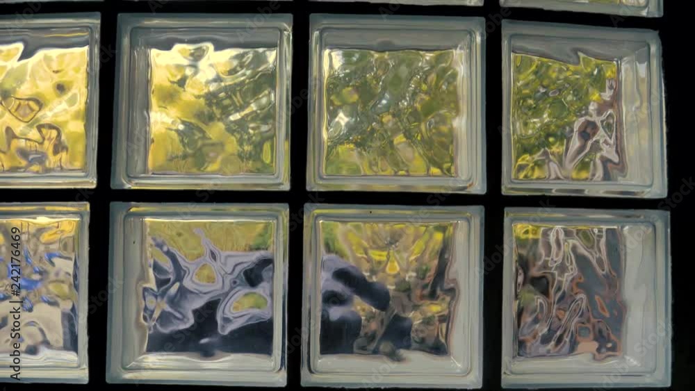 Squashed Window Distorted view through a glass block window. Scenery outside is bent by ...