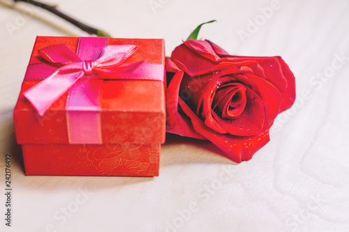 Кув gift box with red bow and rose red. Valentine's day concept.