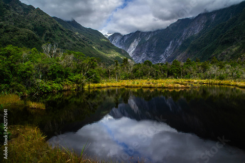 New Zealand tourist popular attractions/destinations concept. Scenic landscape view of valley and Franz Josef Glacier in summer season, located at West Coast, South Island.  © Dajahof