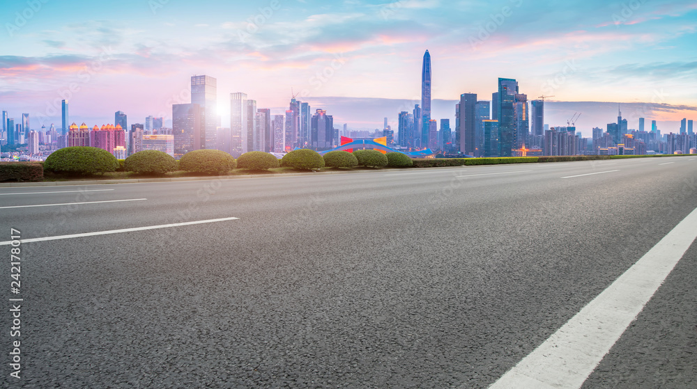 Empty asphalt road along modern commercial buildings in China,s cities Empty asphalt road along modern commercial buildings in China,s cities