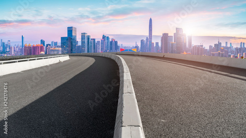 Empty asphalt road along modern commercial buildings in China s cities