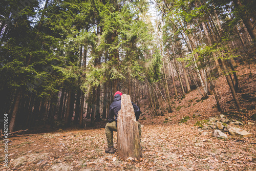 man hiker thinking in the forest in mountain - time to disconnect concept - intentional artificial flare image photo