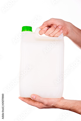 plastic canister in hand on white background