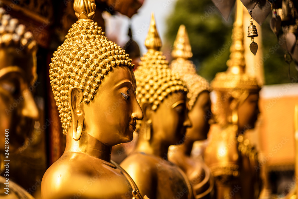 Detail of some golden Buddha statues.