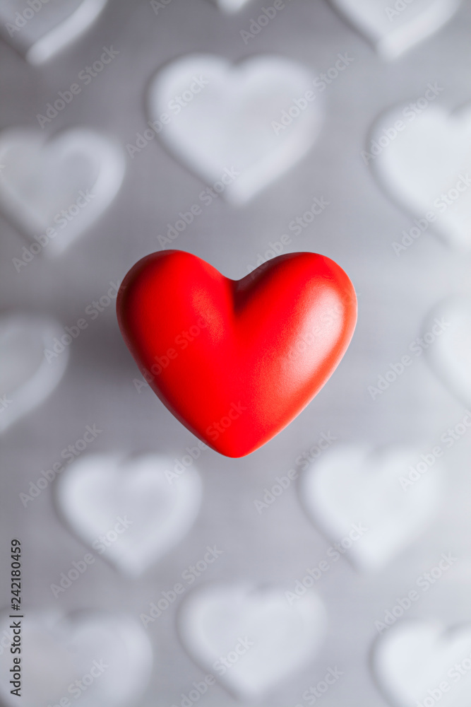 One red heart on the background of gray hearts as a symbol of Valentine's Day One red heart on the background of gray hearts as a symbol of Valentine's Day