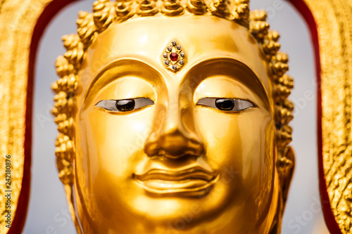 Face of a golden Buddha statue.