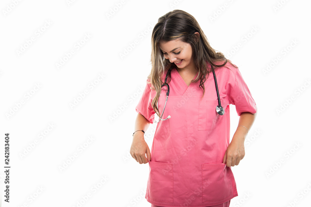 Portrait of beautiful young doctor wearing scrubs checking pockets Portrait of beautiful young doctor wearing scrubs checking pockets