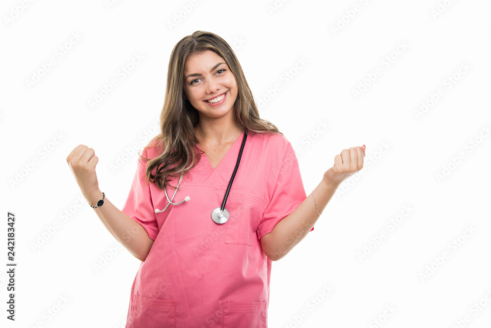 Portrait of beautiful young doctor wearing scrubs holding fists Portrait of beautiful young doctor wearing scrubs holding fists