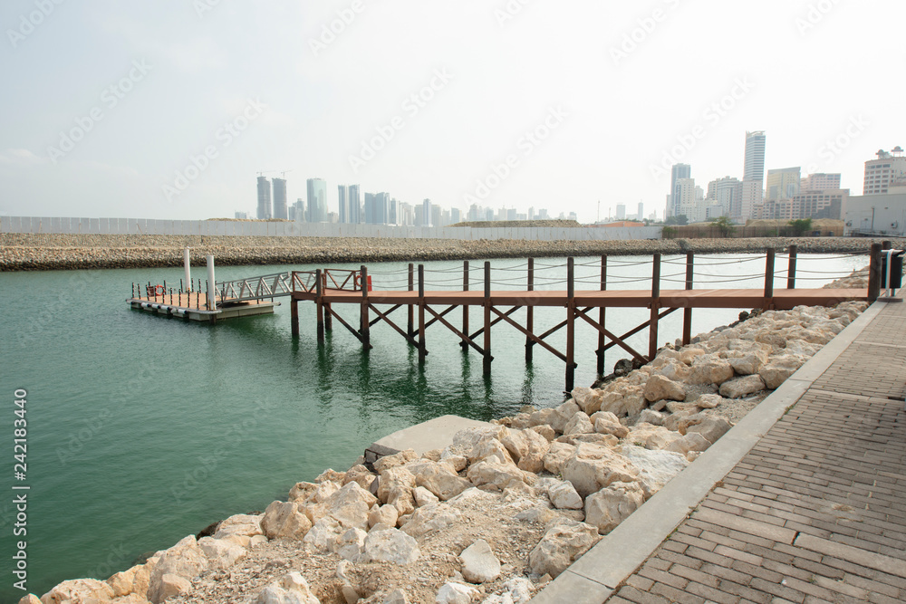luxury wooden port and skyline of Manama in the Kingdom of Bahrain in middle East during midday - Image