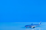 Airplane miniature transport business on blue background