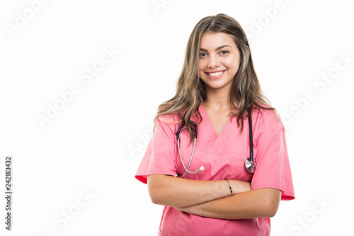 Portrait of beautiful young doctor wearing scrubs standing with arms crossed