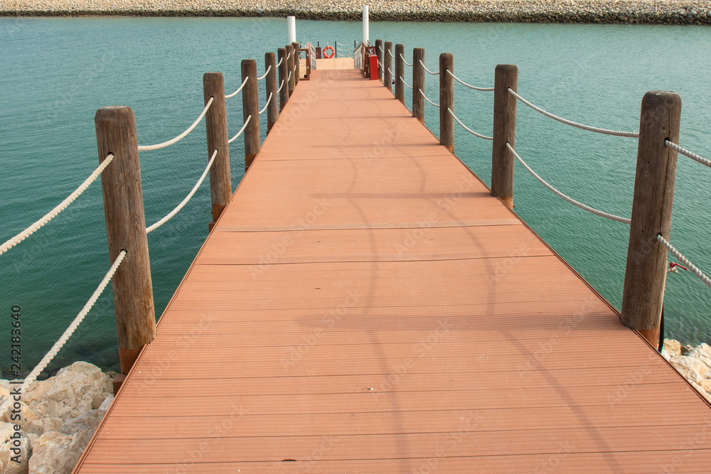 Obraz premium wooden port with rope on water