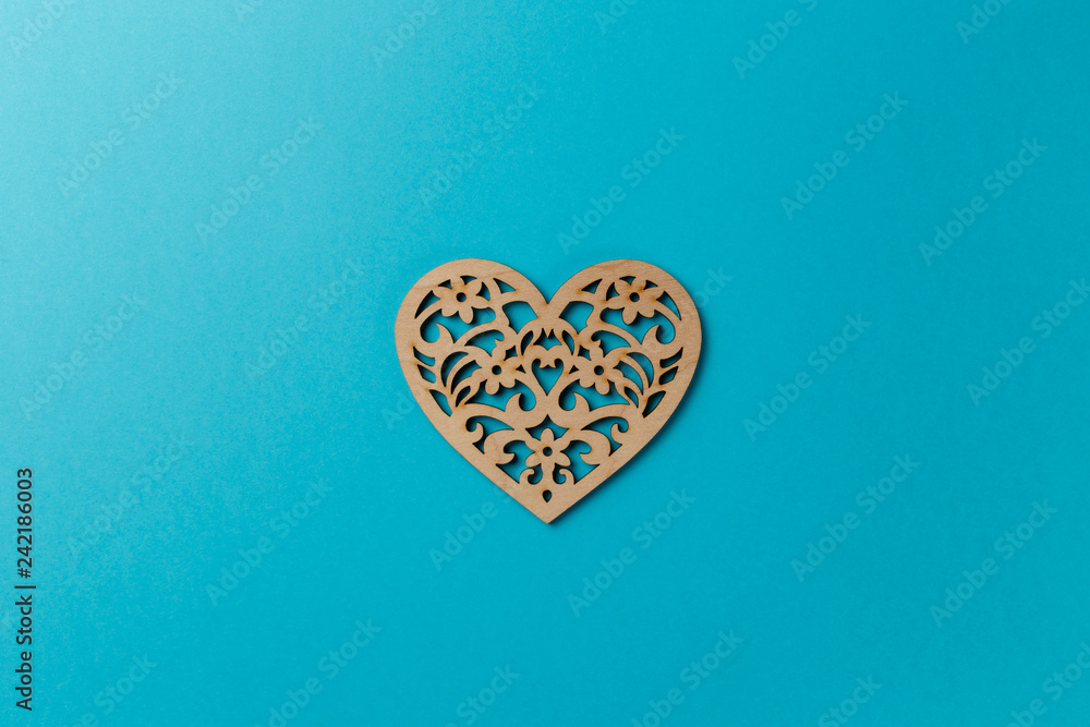 Valentine's Day postcard. Wooden heart on blue background. Copy space. Top view. Flat lay. Pastel colors