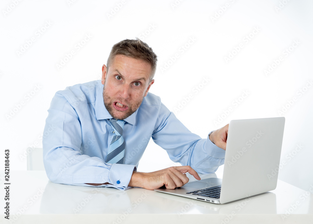 Businessman overwhelmed and desperate at work angry yelling at laptop computer Businessman overwhelmed and desperate at work angry yelling at laptop computer