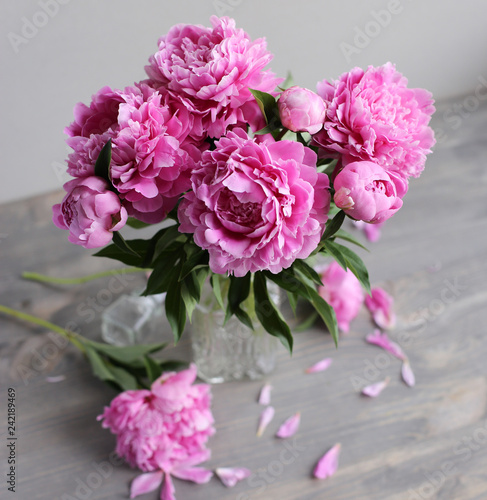 Flowers composition. Pink peony flowers on wooden background. Mothers day. Flat lay, top view.