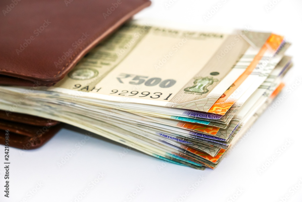 Close up view of wallet with brand new indian 50, 100, 200, 500 rupees banknotes on white background. Close up view of wallet with brand new indian 50, 100, 200, 500 rupees banknotes on white background.