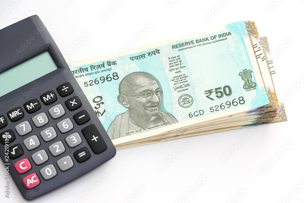 Close up view of calculator over brand new indian 50, 100, 200, 500 rupees banknoteson white background. Close up view of calculator over brand new indian 50, 100, 200, 500 rupees banknoteson white background.