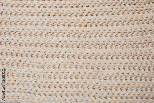 beige knitted texture, top view.