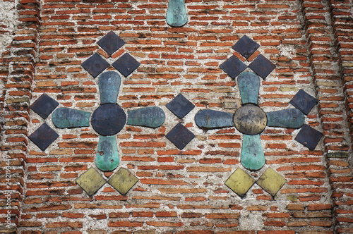 Ancient brick wall of the Kalozha church in Grodno, Belarus. Facade is decorated with majolica tiles. photo