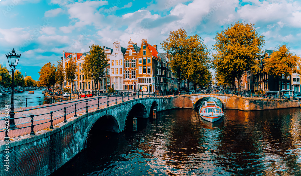 Panorama of Amsterdam. Famous canals und bridges at warm afternoon light. Netherlands - obrazy, fototapety, plakaty 