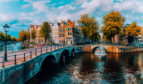 Panorama of Amsterdam. Famous canals und bridges at warm afternoon light. Netherlands