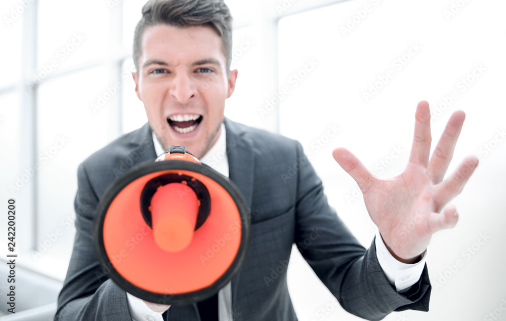 businessman screaming into a megaphone