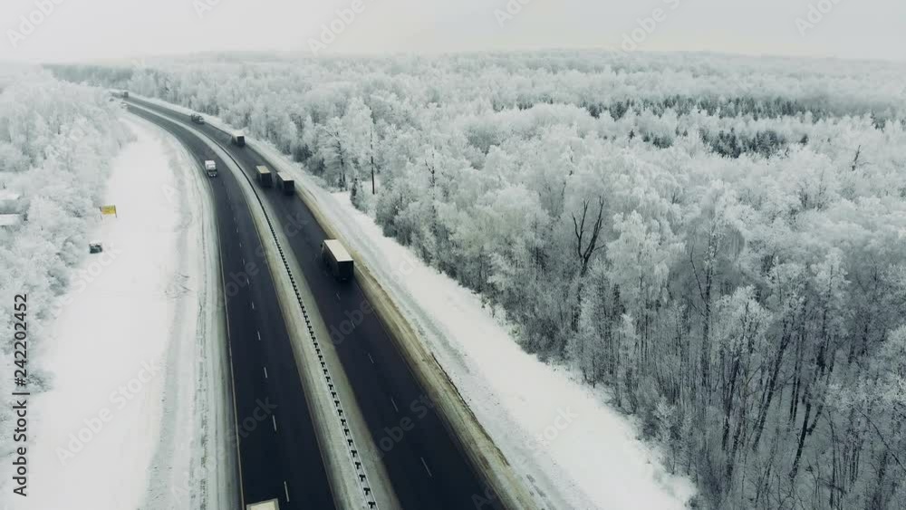 Highway traffic in the middle of the winter, on a windy cold snowy day. Highway traffic in the middle of the winter, on a windy cold snowy day.