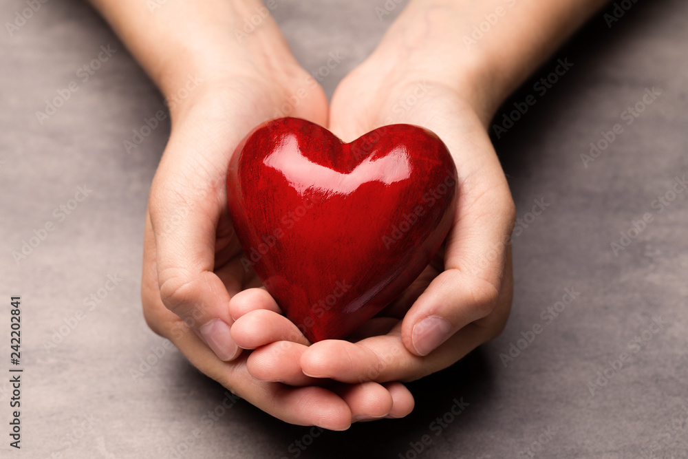 Red wood heart in child hands. Red wood heart in child hands.