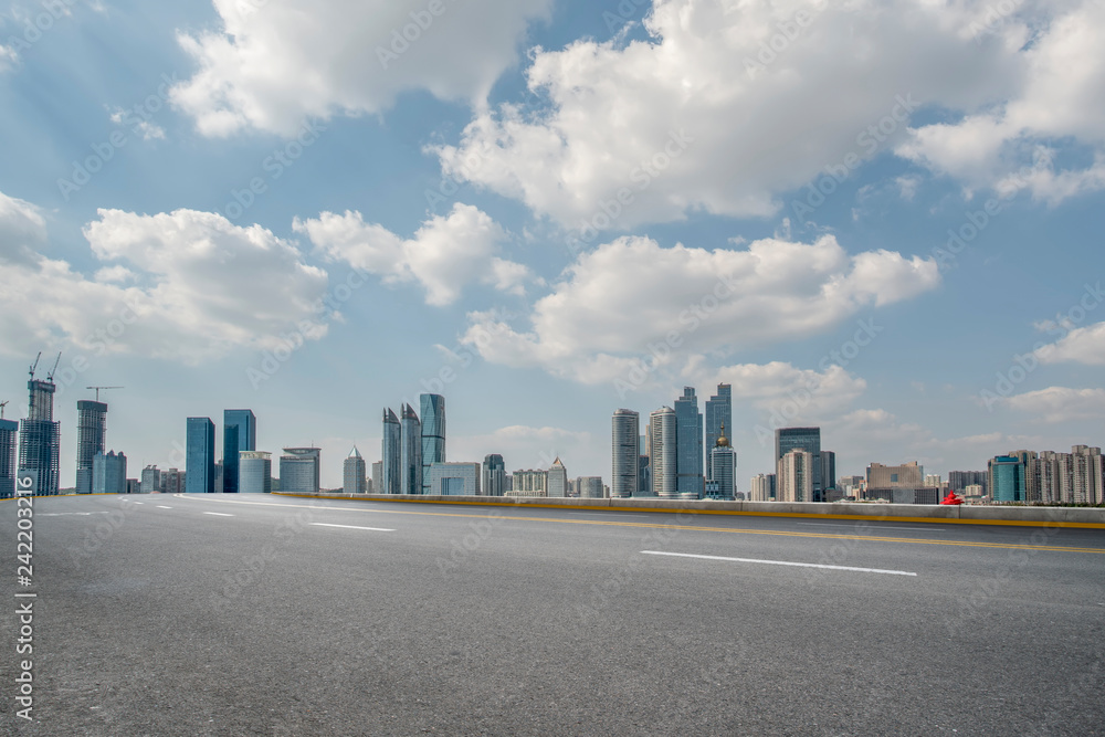Empty asphalt road along modern commercial buildings in China,s cities Empty asphalt road along modern commercial buildings in China,s cities