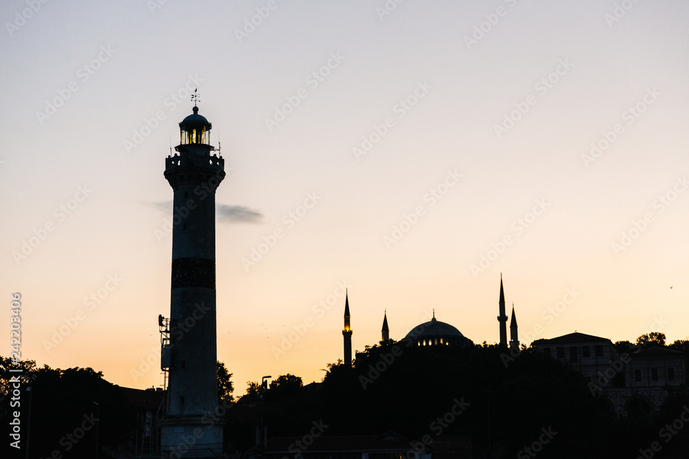 Silhouette of a lighhouse and the famous Hagia Sophia  in Istanbul, Turkey