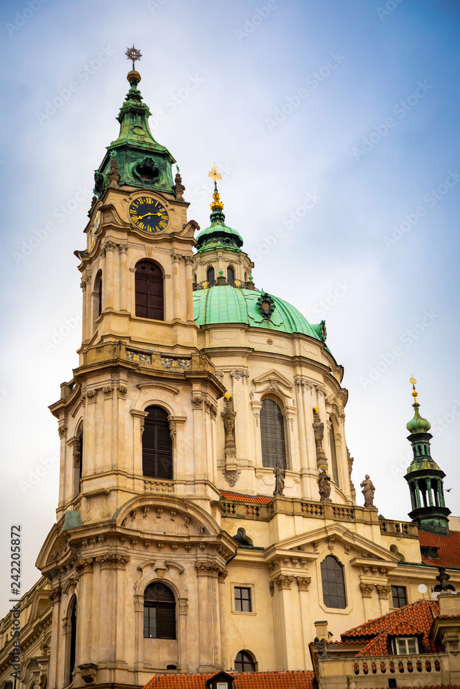 Church of Saint Nicolas or kostel svateho Mikulase, view from mostecka street with people in Prague, Czech Republic
