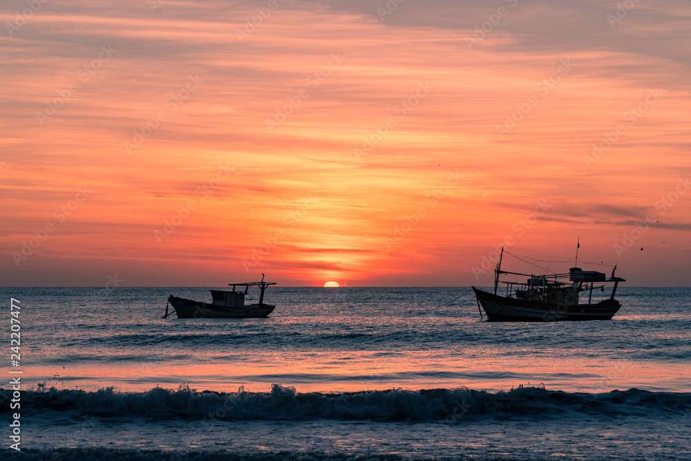 Fishing boats at sunrise on the beach, Brazil