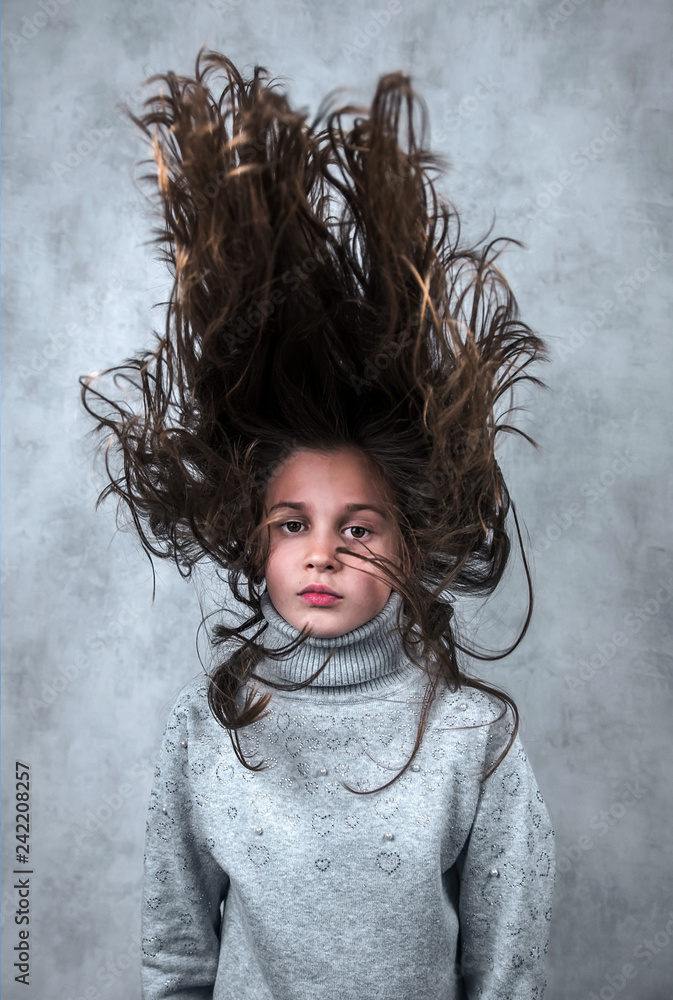 nice girl with an unusual hairstyle. Blast of hair. Stock Photo | Adobe Stock nice girl with an unusual hairstyle. Blast of hair. Stock Photo | Adobe Stock