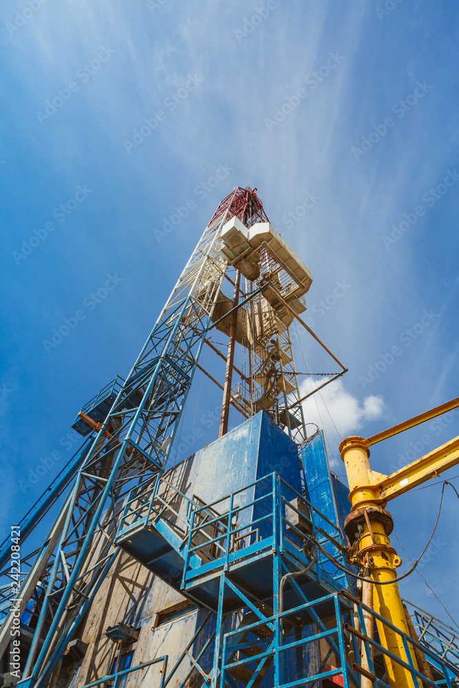 Drilling rig in oil field for drilled into subsurface in order to produced crude. Petroleum Industry Drilling rig in oil field for drilled into subsurface in order to produced crude. Petroleum Industry