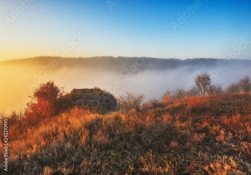 fog over the canyon of the picturesque river. autumn morning in national park