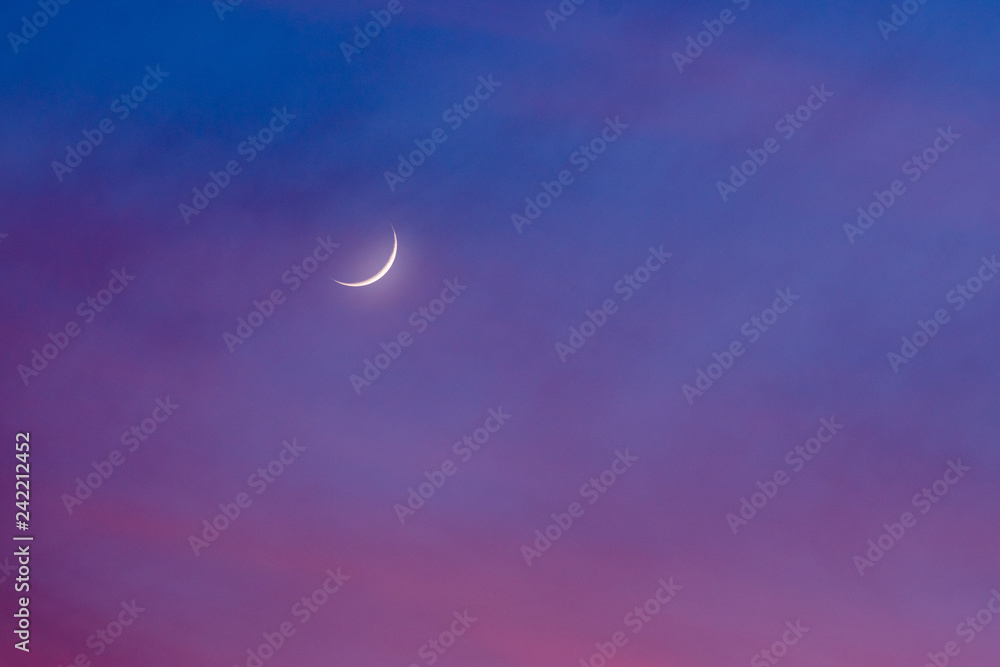 Gibbous waning moon in colorful dawning sky Gibbous waning moon in colorful dawning sky